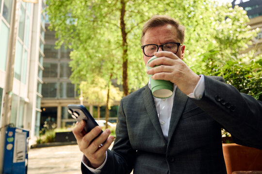 Businessman grabs a takeaway coffee outdoors