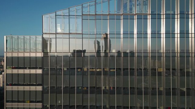 exterior of modern office building from glass and steel, city reflection in mirrors, contemporary architecture of financial district