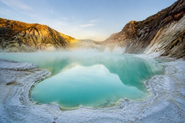 Calm volcanic crater lake with milky blue water and white deposits. © guangyu