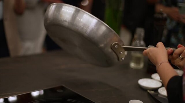 Chef plating gourmet food in a modern kitchen restaurant setting