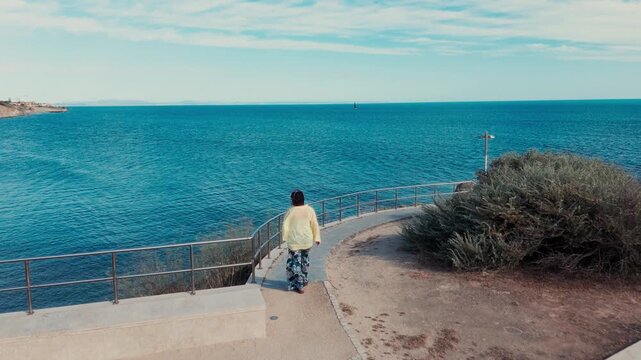 Person Walking Along Miradouro Pedra do Sal, Estoril, Portugal