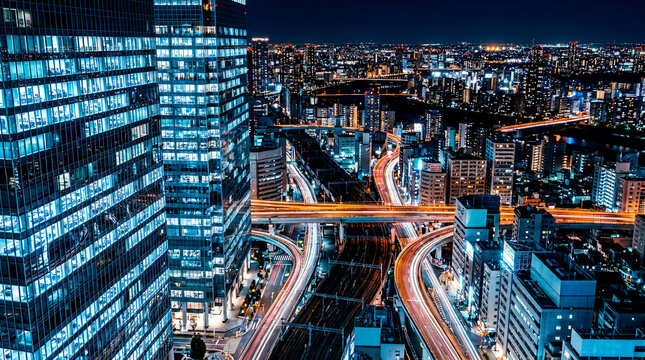 Tokyo city skyline at night with illuminated highways and modern buildings.