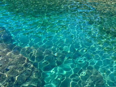 Turquoise crystal clear sea water surface.