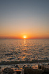 Obraz premium Orange Sunset Over Calm Ocean Background Blur