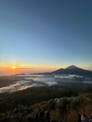 Obraz premium Sunrise over Mount Agung with sea of clouds at Mount Batur, Bali, Indonesia