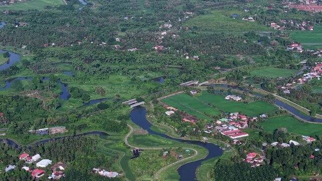 Aerial view reveals a vibrant green landscape. Curving rivers flow through the area at Kubang Semang