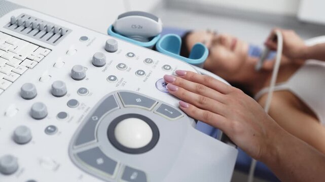 Young woman having her thyroid gland examined with ultrasound in a modern clinic. Concept thyroid health, endocrine diagnostics, ultrasound imaging, medical care, preventive medicine.