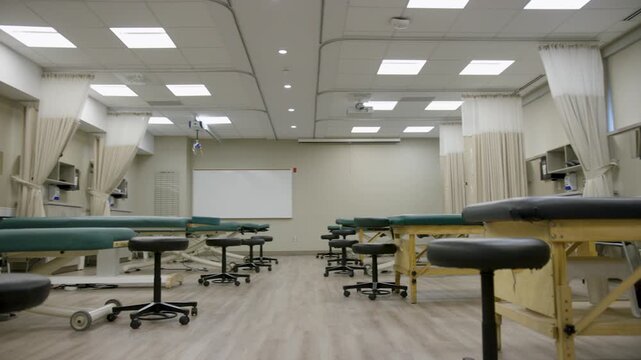 Modern Physical Therapy Training Lab with Treatment Tables and Medical Equipment