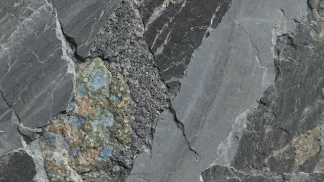 Close up view of fractured rock revealing mineral formations and textured stone surfaces for geological analysis