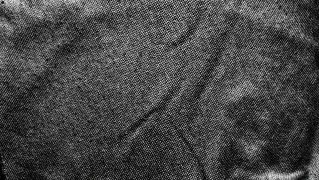 distressed black denim texture showcasing gritty raw weave and high contrast monochromatic creases