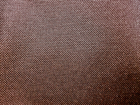 detailed macro view of coarse copper woven textile grid texture serving as rustic abstract background for packaging and web design
