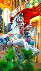 White ponies on a children's carousel © Marina