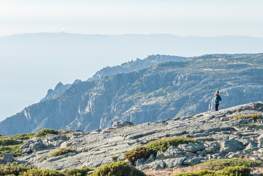 Hiker standing on rocky mountain ridge in Serra da Estrela Portugal