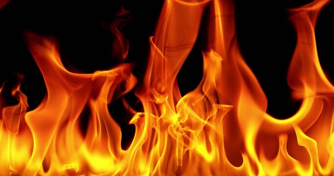 Ultra slow motion fire flames with glowing embers and sparks on black background captured at 1000 FPS. Dramatic combustion effect ideal for cinematic overlays and visual effects.