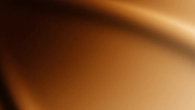 Abstract gold or bronze colored fluid background with dynamic light effect and smooth movement.