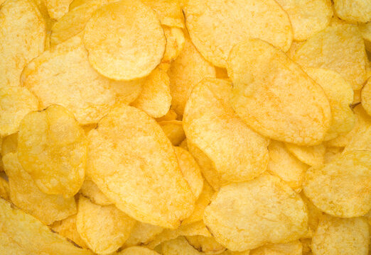 Potato chips texture background top view close up
