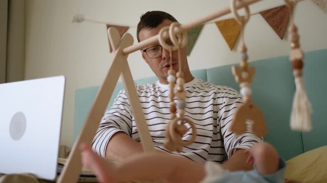 Young single father attempting to work from home on his laptop while caring for his newborn infant, illustrating the struggles and joys of combining freelancing with modern fatherhood