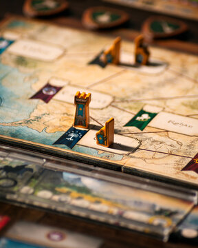 Portrait macro product photography of Lord of the Rings Duel Middle Earth showing fantasy map with wooden warrior orc and tower pieces designed by Antoine Bauza and Bruno Cathala