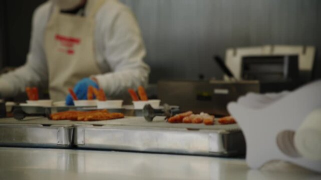 Food factory workers preparing meals on conveyor belt