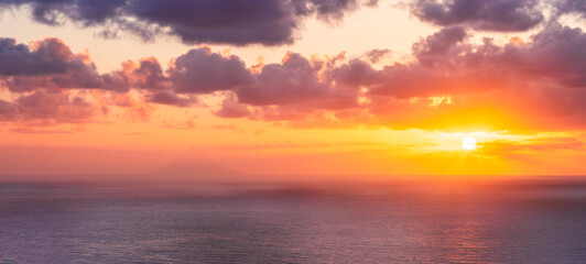 Fototapeta premium beautiful sunrise or sunset seascape with amazing calm sea water with waves and colorful amazing cloudy morning sky on background