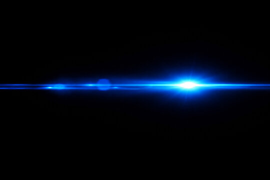 Bright blue lens flare on black background creating an abstract light effect and glow design.