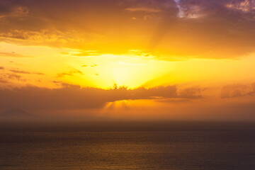 Fototapeta premium beautiful sunrise or sunset seascape with amazing calm sea water with waves and colorful amazing cloudy morning sky on background