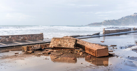 the aftermath of a powerful and devastating hurricane on a sea shore. sea coast embarkment after strong typhoon with ruins and distrustions © Yaroslav