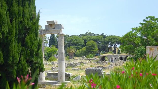 Ancient agora ruins in Kos, Greece, surrounded by lush greenery in slow motion 60fps