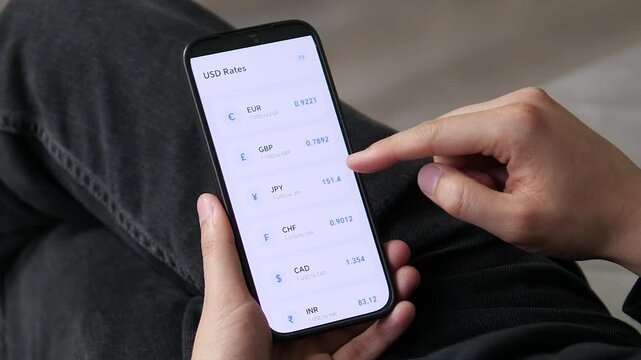 User reviewing a clean, card-based currency list on a mobile device. The structured layout organizes USD rates for EUR, GBP, and JPY. Ideal for financial dashboards, data visualization, and forex app