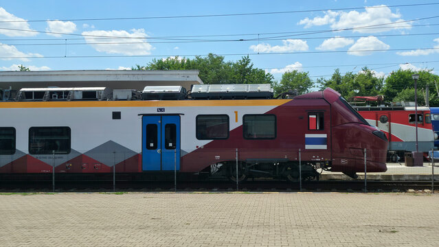 Modern commuter train parked at a railway station platform