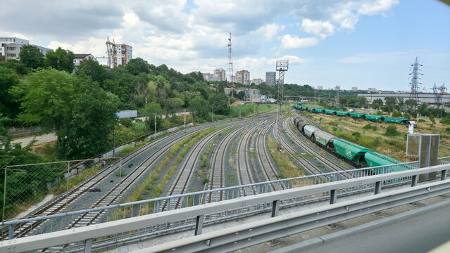 Freight trains on tracks at a railway junction in urban area