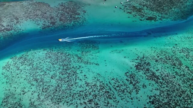 Speedboat cruising through bora bora turquoise lagoon