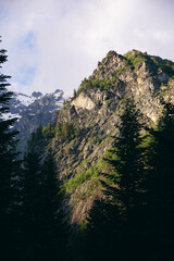 view of mountain peaks and coniferous trees. Sunrise in the mountains of Svaneti, Georgia © Akhtiamova