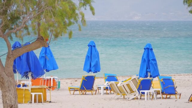 A beach on Kos island with sunbeds and umbrellas in slow motion 60fps