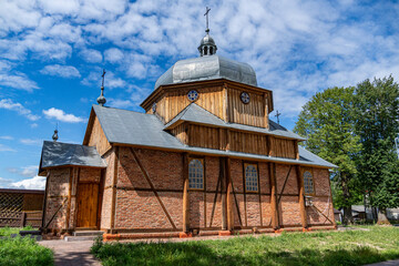 Old wooden Greek Catholic church with shingled roof and onion dome, rural Poland © Kamil