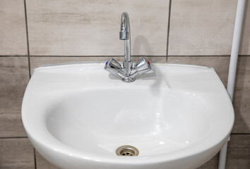 Fototapeta premium White washbasin with a chrome faucet.