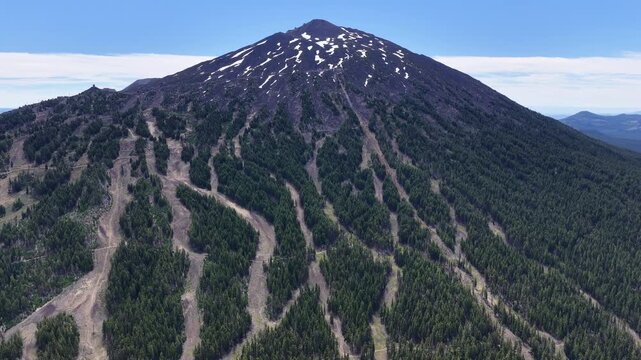 Mt. Bachelor and its many ski trails rise from the Deschutes National Forest in Oregon. This iconic volcanic mountain is part of the Cascade Range and just 22 miles from Bend.