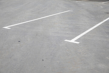 Fototapeta premium White painted markings on the asphalt for car parking.