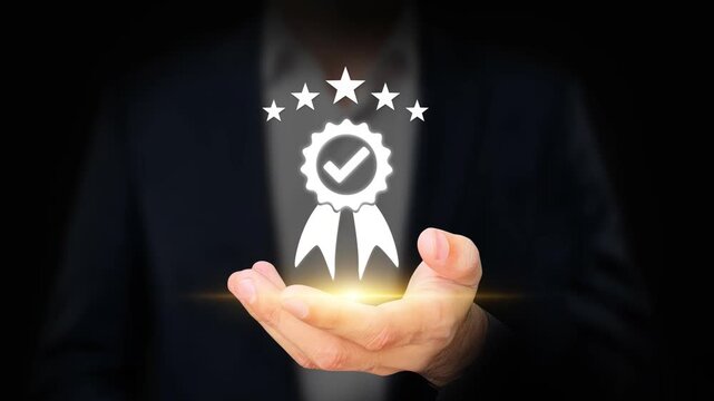 Standard Quality Control, ISO Standardization. Businessman Hand Holding Quality Assurance Badge. Compliance Certification, Business Excellence, Regulatory Standards, Process Improvement. 4K Video