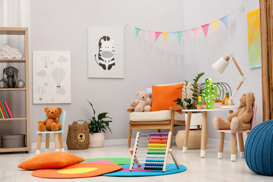 Different toys and furniture in child's room. Interior design