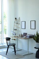 Fototapeta premium Workplace with laptop, stationery and coffee on table in office