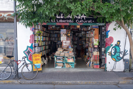 Guadalajara, Mexico - March 26 2026: Vibrant entrance of El Laberinto Cultural, a charming used bookstore in downtown Guadalajara. Showcases piles of books, unique street art, and a parked bicycle