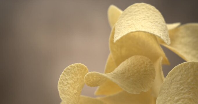 Potato chips flying in slow motion 1000 fps against blue background