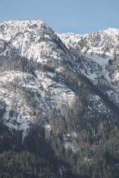 Snowy Tantalus mountain range seen from the Eagle Run dike in Brackendale during a winter season in Squamish, British Columbia, Canada