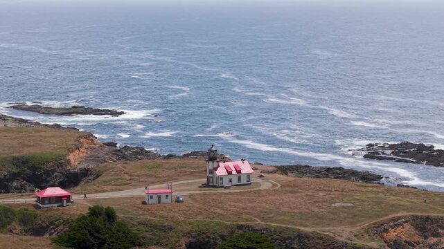 Aerial shots capture Point Cabrillo Lighthouse overlooking the Pacific Ocean near Mendocino and Fort Bragg California at various times.