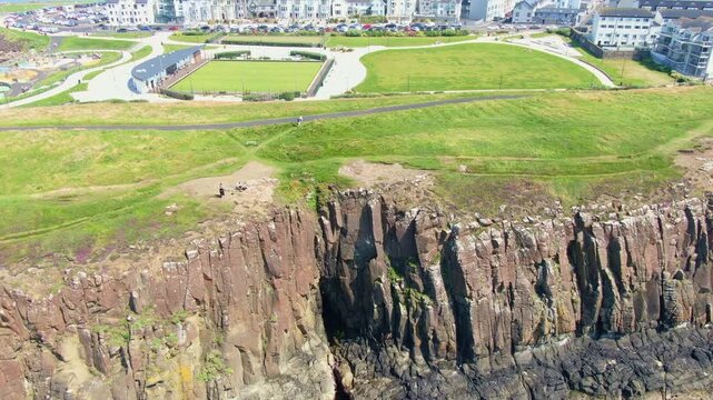 Aerial View of Portrush, Northern Ireland Coastal town on Coast of Atlantic Ocean. Drone Video of Beach and Buildings 