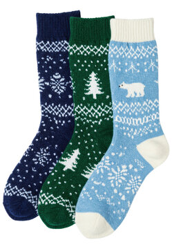 three folded pairs of thick, icy blue and emerald wool knitted socks displaying detailed fair isle patterns (polar bears, pines). clean studio flat lay on white with copy space. concept of cozy