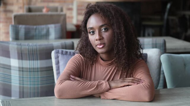 A beautiful young female blogger communicates through an online video call with subscribers recording stories for social networks. Happy African American woman talking on video call