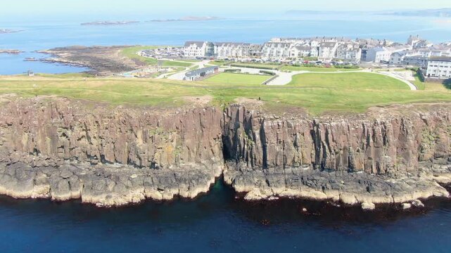 Aerial View of Portrush, Northern Ireland Coastal town on Coast of Atlantic Ocean. Drone Video of Beach and Buildings 