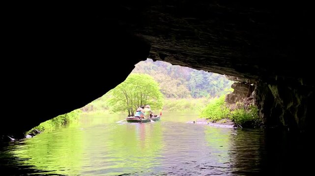 Video of a Rowing Boat Navigating Through a Dark Cave Tunnel Toward Natural Light on a River in Ninh Binh, Vietnam